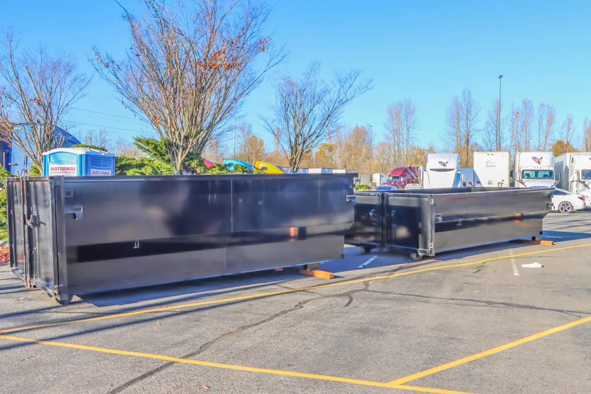 Professional dumpster rental service with roll-off container on residential driveway in Tonawanda